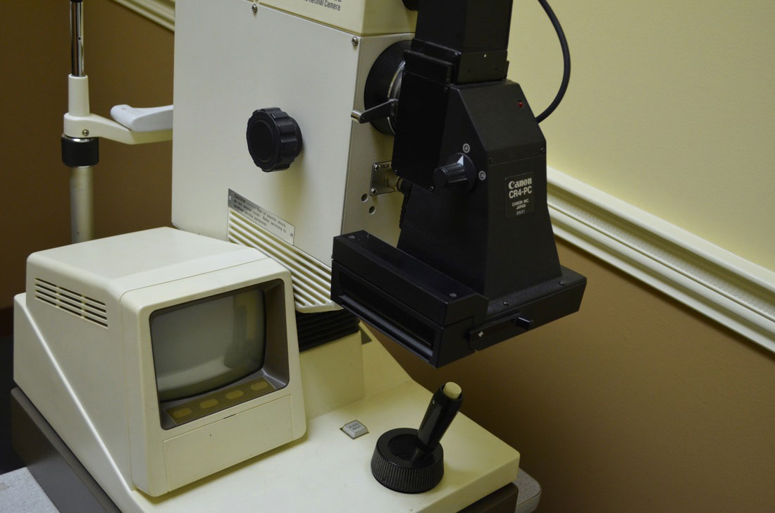 The image shows a microscope with an attached camera on a laboratory table, set up for scientific observation or documentation.