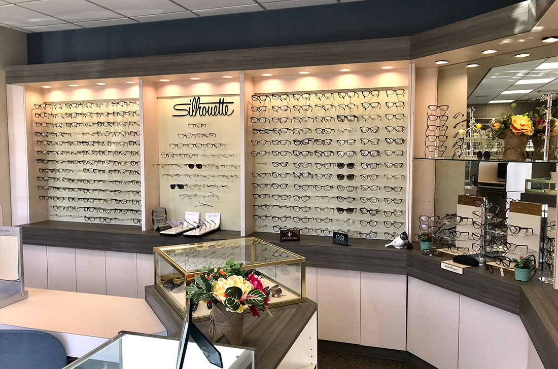 An optical shop with a display of eyeglasses and frames, showcasing various styles and colors.