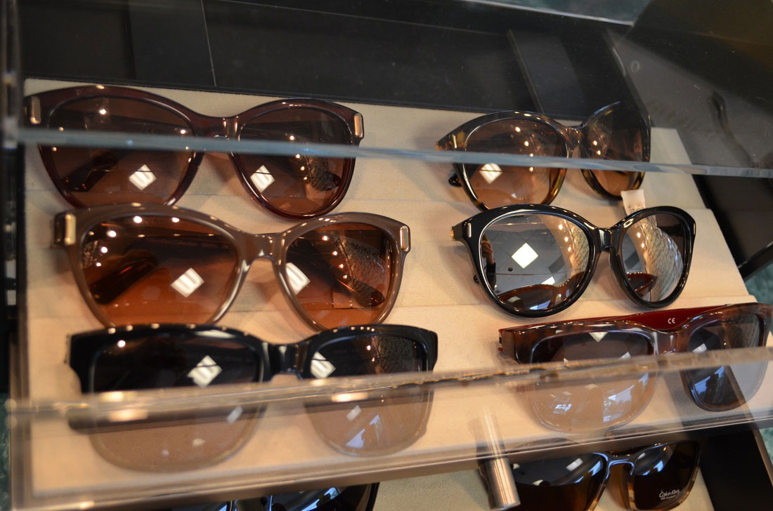 A collection of sunglasses on display, showcasing various styles and colors.