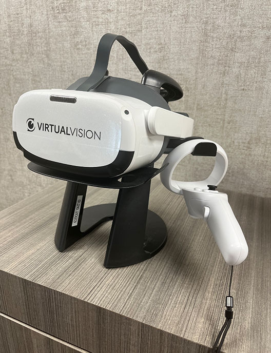 An image featuring a VR headset with the brand VR Vision on it, placed on a stand.